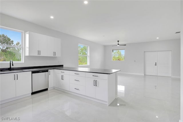 1072 Norton Ave S, Lehigh Acres, FL 33974 - kitchen with stainless steel dishwasher, a sink, a peninsula, dark countertops, and ceiling fan