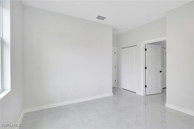 1072 Norton Ave S, Lehigh Acres, FL 33974 - empty room featuring baseboards and light tile patterned flooring
