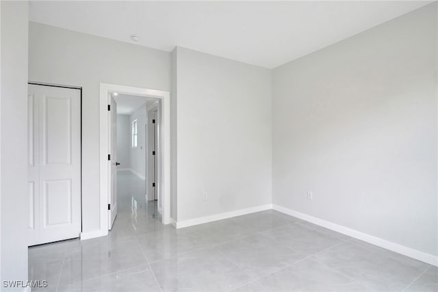 1072 Norton Ave S, Lehigh Acres, FL 33974 - spare room with baseboards and light tile patterned floors