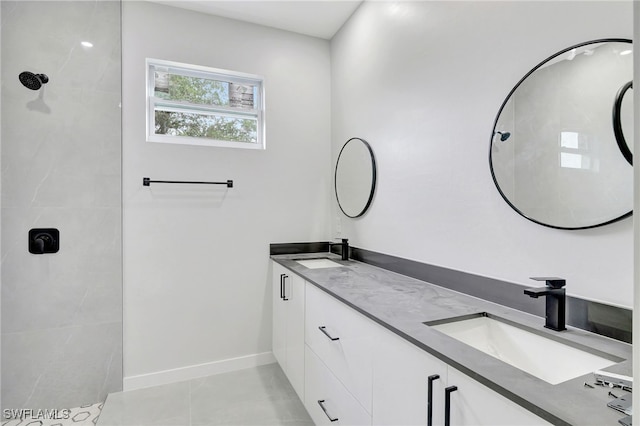 1072 Norton Ave S, Lehigh Acres, FL 33974 - full bathroom featuring double vanity, a tile shower, baseboards, and tile patterned flooring