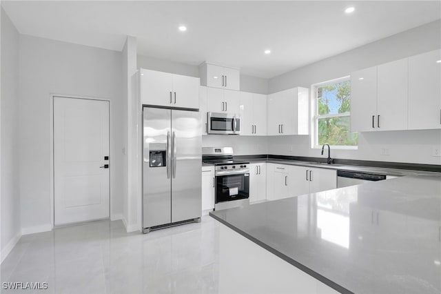 1072 Norton Ave S, Lehigh Acres, FL 33974 - kitchen with stainless steel appliances, dark countertops, recessed lighting, white cabinetry, and light tile patterned floors