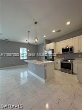 426 Mercedes Ct, Lehigh Acres, FL 33972 - kitchen with stainless steel appliances, recessed lighting, and decorative light fixtures