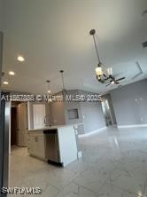 426 Mercedes Ct, Lehigh Acres, FL 33972 - kitchen with a chandelier, open floor plan, decorative light fixtures, baseboards, and dishwasher