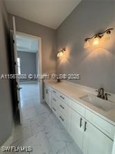 426 Mercedes Ct, Lehigh Acres, FL 33972 - bathroom featuring double vanity and marble look tile flooring