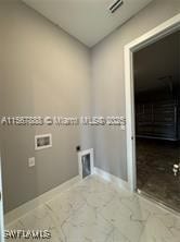 426 Mercedes Ct, Lehigh Acres, FL 33972 - laundry room featuring washer hookup, baseboards, and marble look tile flooring