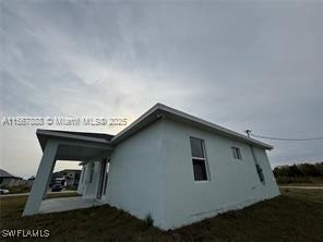 426 Mercedes Ct, Lehigh Acres, FL 33972 - view of home's exterior featuring stucco siding