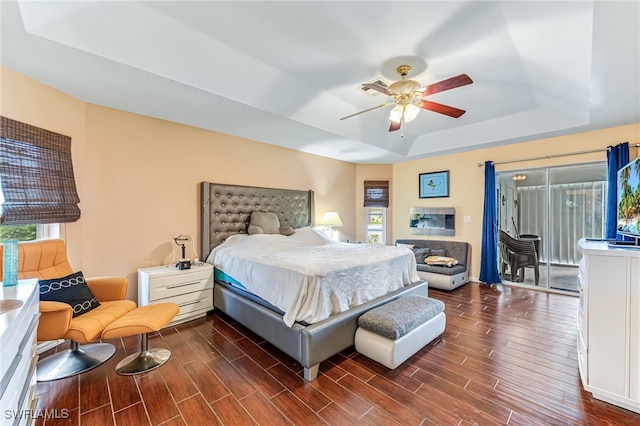 1927 SW 48th Ln, Cape Coral, FL 33914 - bedroom with a raised ceiling, dark wood-style floors, and a ceiling fan