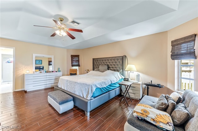 1927 SW 48th Ln, Cape Coral, FL 33914 - bedroom featuring a tray ceiling, wood finished floors, ceiling fan, and baseboards