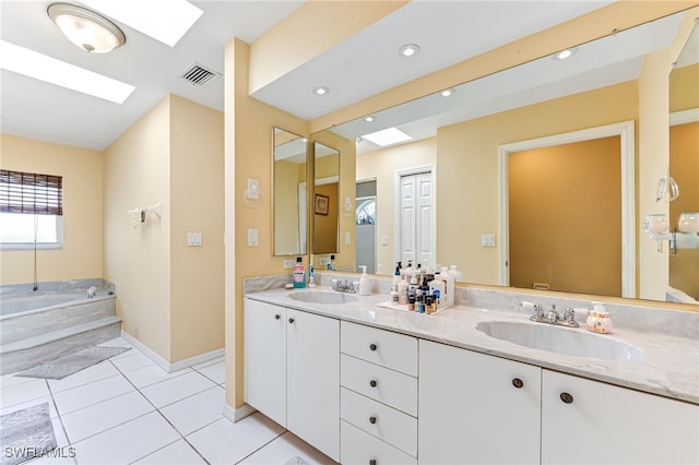 1927 SW 48th Ln, Cape Coral, FL 33914 - full bathroom featuring a skylight, double vanity, a garden tub, tile patterned flooring, and baseboards