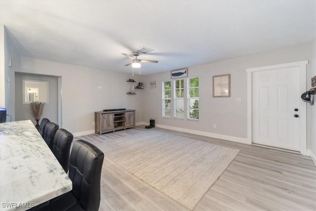 51-55 Lake St, North Fort Myers, FL 33903 - living area with light wood-type flooring, a ceiling fan, and baseboards