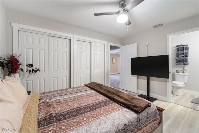 51-55 Lake St, North Fort Myers, FL 33903 - bedroom featuring multiple closets, wood finished floors, baseboards, ensuite bathroom, and a ceiling fan