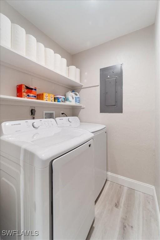 51-55 Lake St, North Fort Myers, FL 33903 - laundry area featuring electric panel, washing machine and dryer, light wood-type flooring, and baseboards