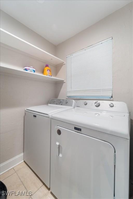 51-55 Lake St, North Fort Myers, FL 33903 - laundry room featuring washer and dryer, light tile patterned floors, and baseboards