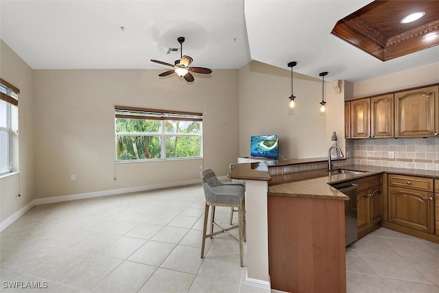 8375 Whisper Trace Ln Unit M203, Naples, FL 34114 - kitchen with a sink, a peninsula, light tile patterned floors, and tasteful backsplash