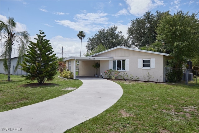 13219 2nd St, Fort Myers, FL 33905 - ranch-style home with concrete driveway, an attached carport, central AC, and stucco siding