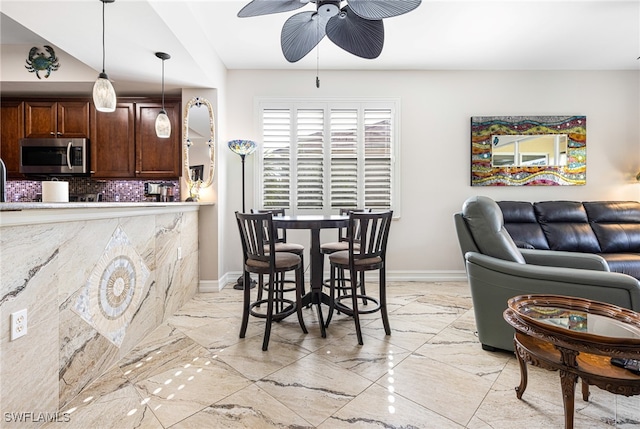 10530 Amiata Way Unit 201, Fort Myers, FL 33913 - dining area featuring a ceiling fan, light marble finish floors, and baseboards
