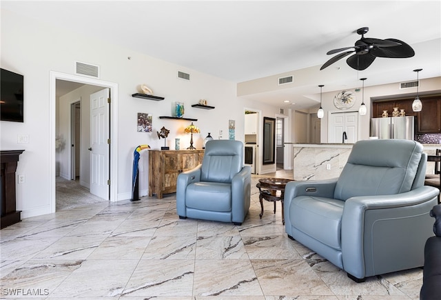 10530 Amiata Way Unit 201, Fort Myers, FL 33913 - living area with ceiling fan, baseboards, and light marble finish floors