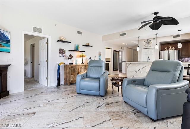 10530 Amiata Way Unit 201, Fort Myers, FL 33913 - living area featuring a ceiling fan, baseboards, and light marble finish floors