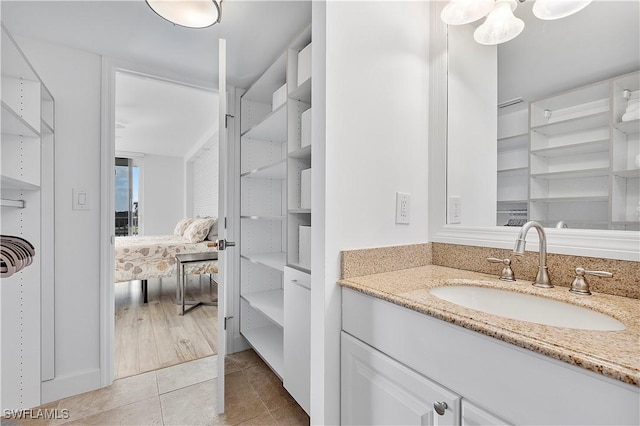 5 Bluebill Ave Unit 410, Naples, FL 34108 - bathroom featuring vanity, tile patterned flooring, and a chandelier