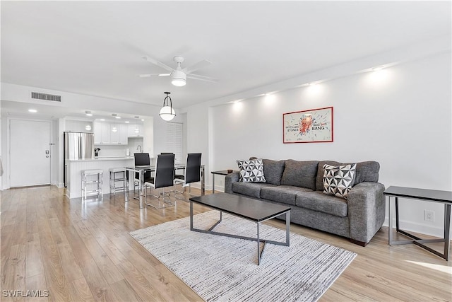 5 Bluebill Ave Unit 410, Naples, FL 34108 - living room with light wood-type flooring and ceiling fan