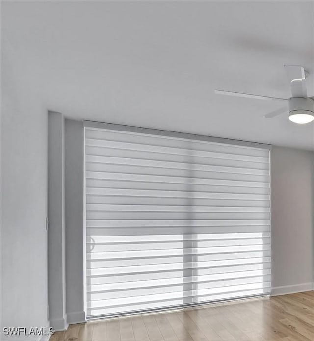 5 Bluebill Ave Unit 410, Naples, FL 34108 - detailed view of wood finished floors and ceiling fan