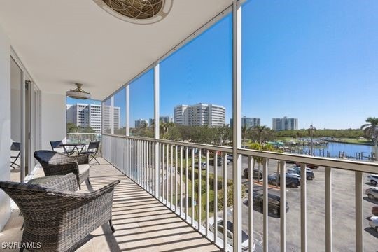5 Bluebill Ave Unit 410, Naples, FL 34108 - balcony featuring a water view and a city view