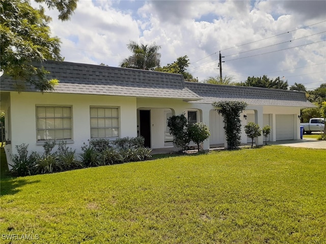2979 Cortez Blvd, Fort Myers, FL 33901 - view of front of property with roof with shingles, an attached garage, a front lawn, and driveway