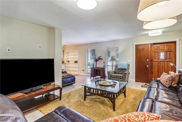 2979 Cortez Blvd, Fort Myers, FL 33901 - living room with light tile patterned floors, baseboards, and built in features