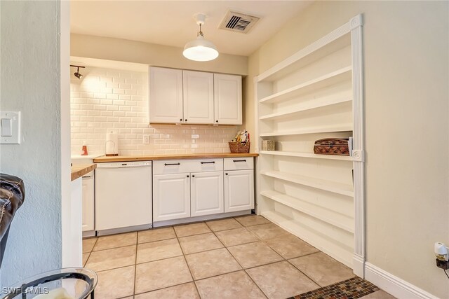 2979 Cortez Blvd, Fort Myers, FL 33901 - kitchen featuring white dishwasher, white cabinets, light tile patterned floors, open shelves, and decorative backsplash