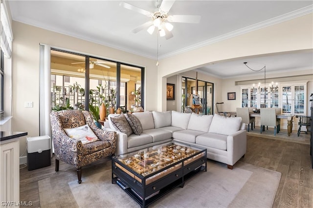 11640 Court Of Palms Unit 304, Fort Myers, FL 33908 - living room featuring a ceiling fan, wood finished floors, arched walkways, ornamental molding, and a chandelier