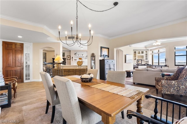 11640 Court Of Palms Unit 304, Fort Myers, FL 33908 - dining area with arched walkways, crown molding, a chandelier, light wood-style flooring, and a ceiling fan