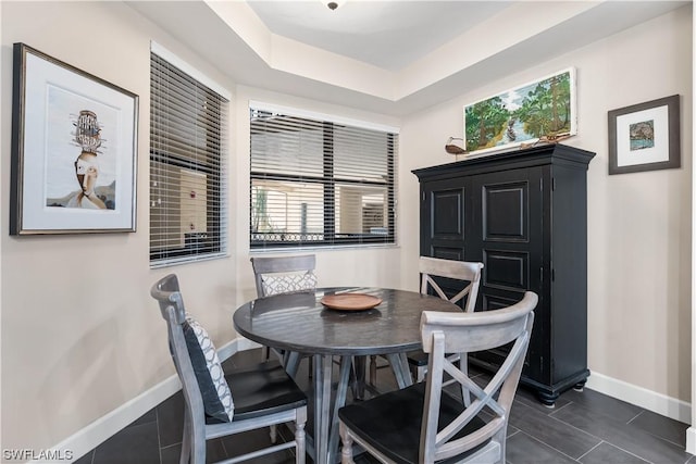 11640 Court Of Palms Unit 304, Fort Myers, FL 33908 - dining space with dark tile patterned flooring and a tray ceiling