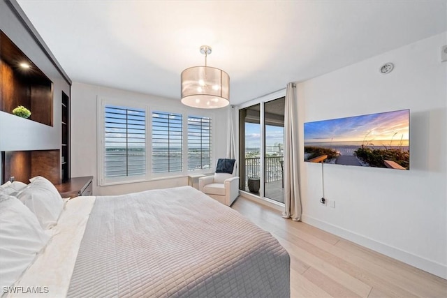 2104 W First St Unit 1402, Fort Myers, FL 33901 - bedroom featuring light wood-style flooring, access to exterior, and baseboards