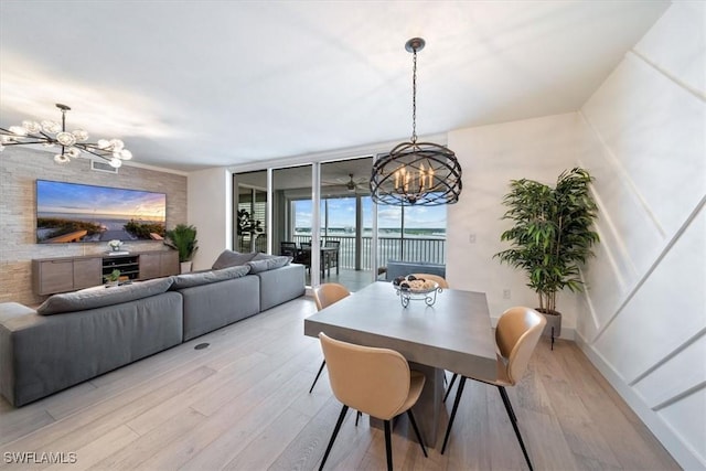 2104 W First St Unit 1402, Fort Myers, FL 33901 - dining room featuring a chandelier, light wood-style flooring, and floor to ceiling windows