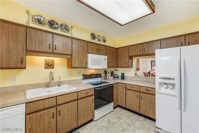 6843 Bogey Dr, Fort Myers, FL 33919 - kitchen with white appliances, a sink, light countertops, and brown cabinets
