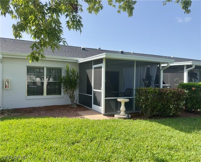 6843 Bogey Dr, Fort Myers, FL 33919 - back of house with a sunroom, a lawn, and stucco siding