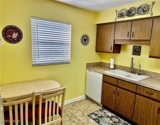6843 Bogey Dr, Fort Myers, FL 33919 - kitchen with white dishwasher, a sink, and baseboards