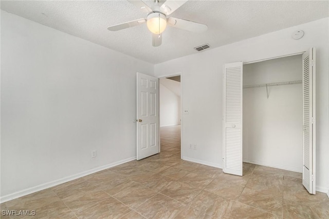 5737 Whitaker Rd Unit C203, Naples, FL 34112 - unfurnished bedroom featuring a closet, a textured ceiling, ceiling fan, and baseboards