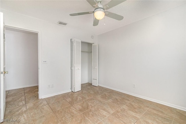 5737 Whitaker Rd Unit C203, Naples, FL 34112 - unfurnished bedroom with a closet, a ceiling fan, and baseboards