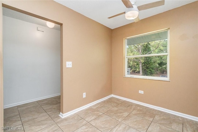 5737 Whitaker Rd Unit C203, Naples, FL 34112 - empty room with a ceiling fan, light tile patterned floors, and baseboards