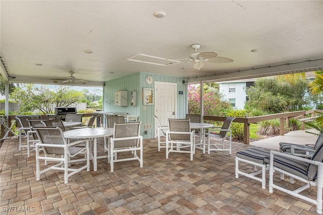 5737 Whitaker Rd Unit C203, Naples, FL 34112 - view of patio featuring a ceiling fan, outdoor dining area, and an outdoor kitchen