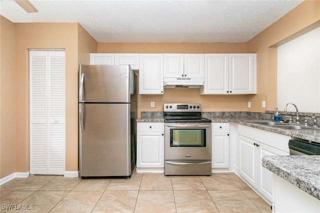 5737 Whitaker Rd Unit C203, Naples, FL 34112 - kitchen with stainless steel appliances, under cabinet range hood, a sink, and white cabinets