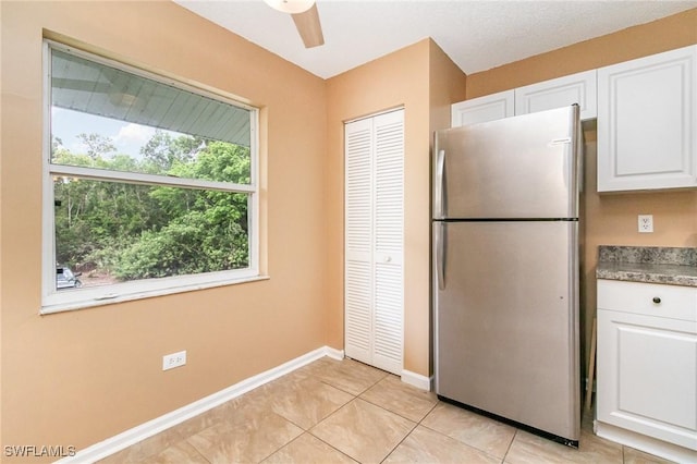 5737 Whitaker Rd Unit C203, Naples, FL 34112 - kitchen featuring freestanding refrigerator, white cabinetry, a ceiling fan, light tile patterned flooring, and baseboards