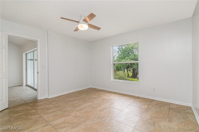 5737 Whitaker Rd Unit C203, Naples, FL 34112 - spare room featuring a ceiling fan, light tile patterned flooring, and baseboards