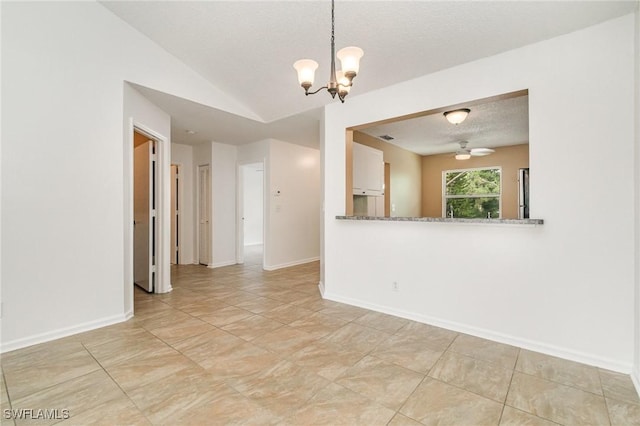 5737 Whitaker Rd Unit C203, Naples, FL 34112 - empty room featuring a chandelier, baseboards, lofted ceiling, light tile patterned flooring, and a textured ceiling