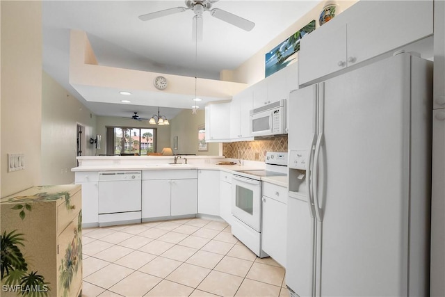 6810 Beach Resort Dr Unit 13, Naples, FL 34114 - kitchen with white appliances, ceiling fan, a peninsula, and light countertops