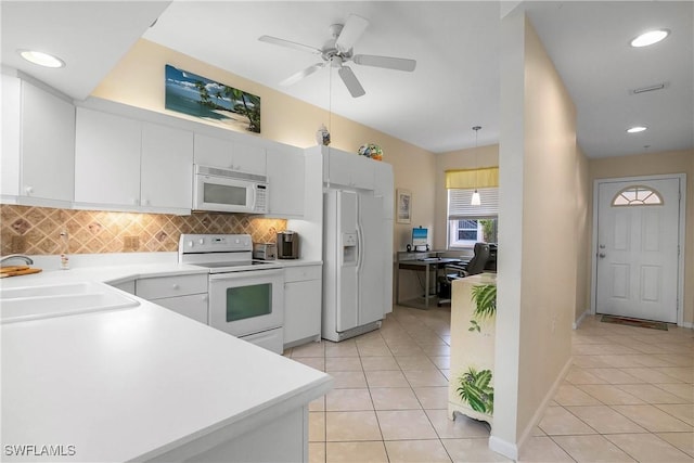 6810 Beach Resort Dr Unit 13, Naples, FL 34114 - kitchen featuring white appliances, light tile patterned floors, a sink, decorative backsplash, and white cabinets