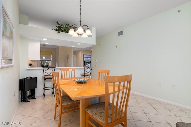 6810 Beach Resort Dr Unit 13, Naples, FL 34114 - dining room with a chandelier, light tile patterned flooring, and baseboards