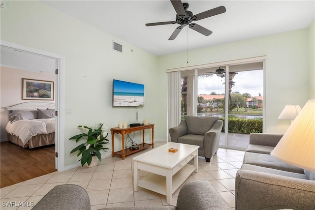 6810 Beach Resort Dr Unit 13, Naples, FL 34114 - living area with light tile patterned floors, a ceiling fan, and baseboards