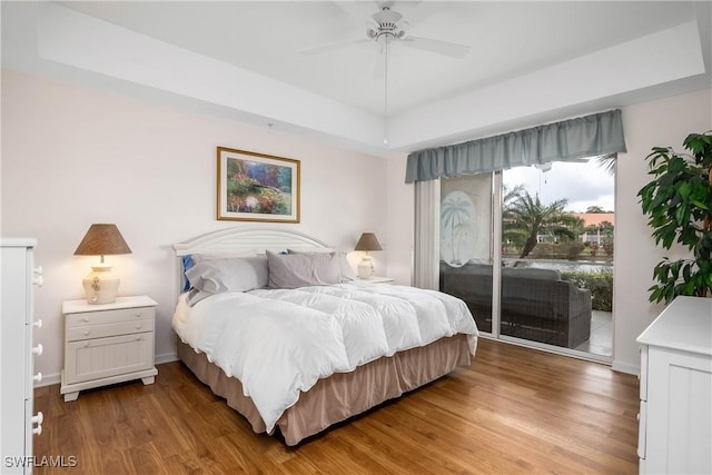 6810 Beach Resort Dr Unit 13, Naples, FL 34114 - bedroom with access to exterior, light wood-style flooring, ceiling fan, and a raised ceiling
